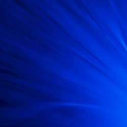 Abstract blue background with light rays emanating from the bottom right corner creating a dynamic effect.