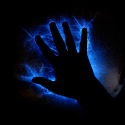 Silhouette of a hand reaching out against an electrifying blue lightning background.