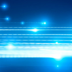 Abstract blue digital background with glowing horizontal lines and light particles.