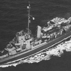 Black and white aerial view of a military patrol boat sailing on the ocean.