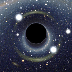 A black hole in space surrounded by stars and a glowing gravitational lensing effect.