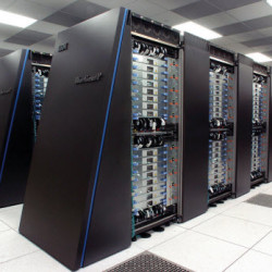 A row of black server racks with multiple network cables and hardware components in a data center.