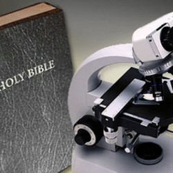 A Holy Bible placed next to a microscope on a wooden surface, symbolizing the intersection of science and faith.