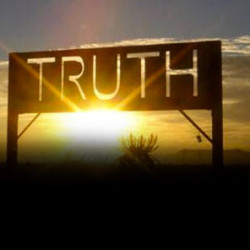 A glowing sign with the word 'TRUTH' illuminated against a sunset backdrop.