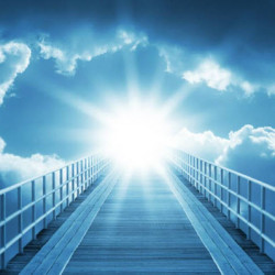 A bright sun shining through clouds at the end of a wooden bridge with railings extending into the sky.