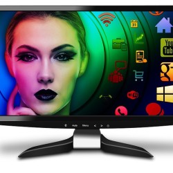 A computer monitor displaying a colorful digital artwork of a woman's face surrounded by vibrant icons and symbols.