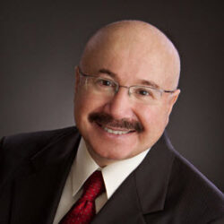 Smiling man in a suit and tie.
