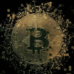 A digital representation of a Bitcoin symbol surrounded by pixelated golden particles on a dark background.