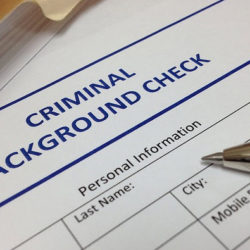 Close-up of a criminal background check form with sections for personal information.