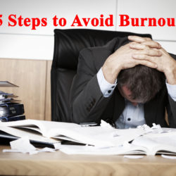 A stressed businessman surrounded by paperwork, holding his head in frustration at a cluttered desk.