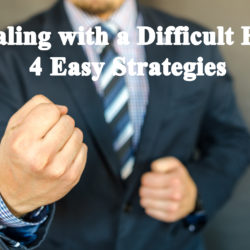 A person in a suit making a fist, symbolizing dealing with difficult people and strategies for conflict resolution.