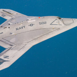 A white jet fighter flying through the air.